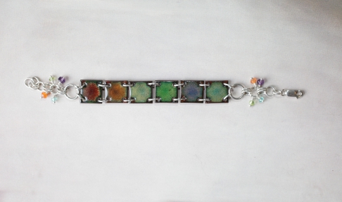 Rainbow Bracelet / reversible by Catherine DeYoung | Vitreous (glass) enamel on copper with all sterling silver findings.
Gemstone drops are amethyst, Rainbow Bracelet / reversible